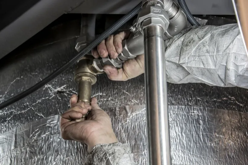 Plumber installing pipes by hand