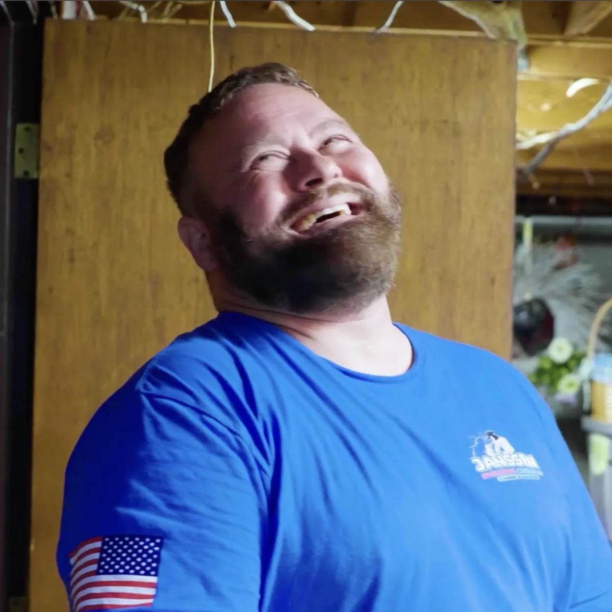 Steve Janssen, owner of Janssen Heating Cooling Plumbing and Insulation, laughing on the job
